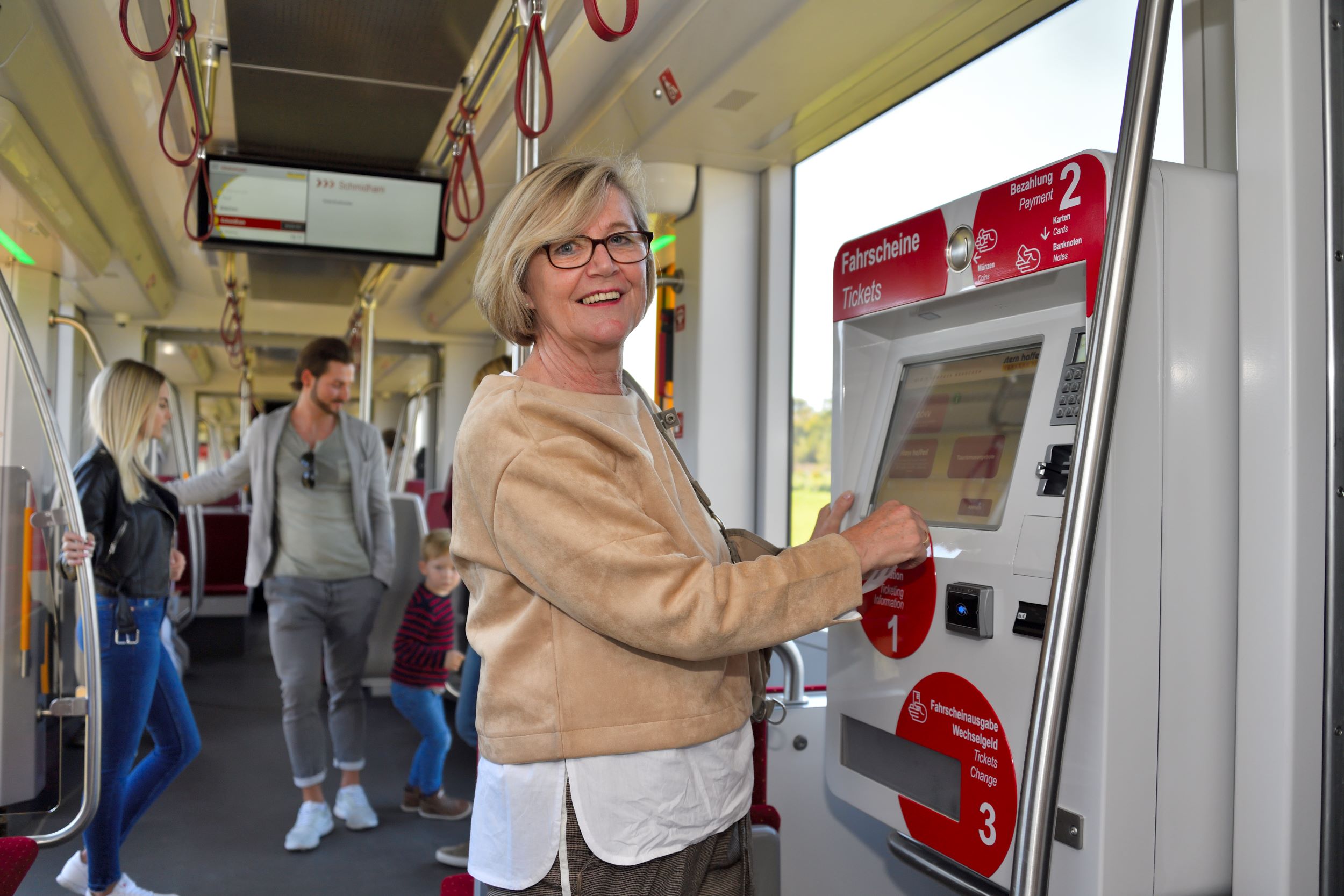 Pensionistin beim Ticketkauf am Ticketautomaten
